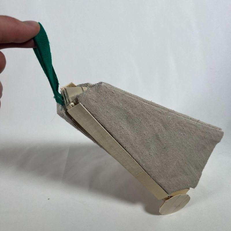 Triangle Cart model, closed, held by its strap
