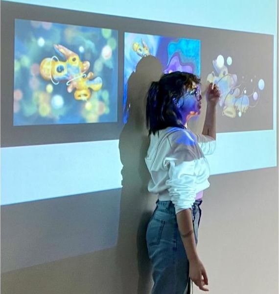 A student presenting her projected work during critique