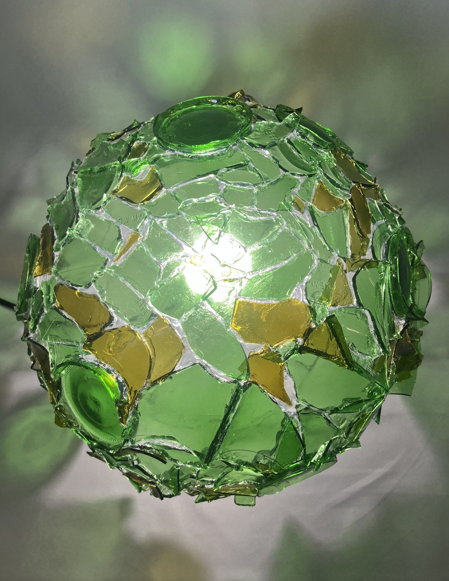 Reassembled Light: a Tiffany-style lamp made from broken recycled bottles set like a mosaic, by Kyle, a portfolio-development student
