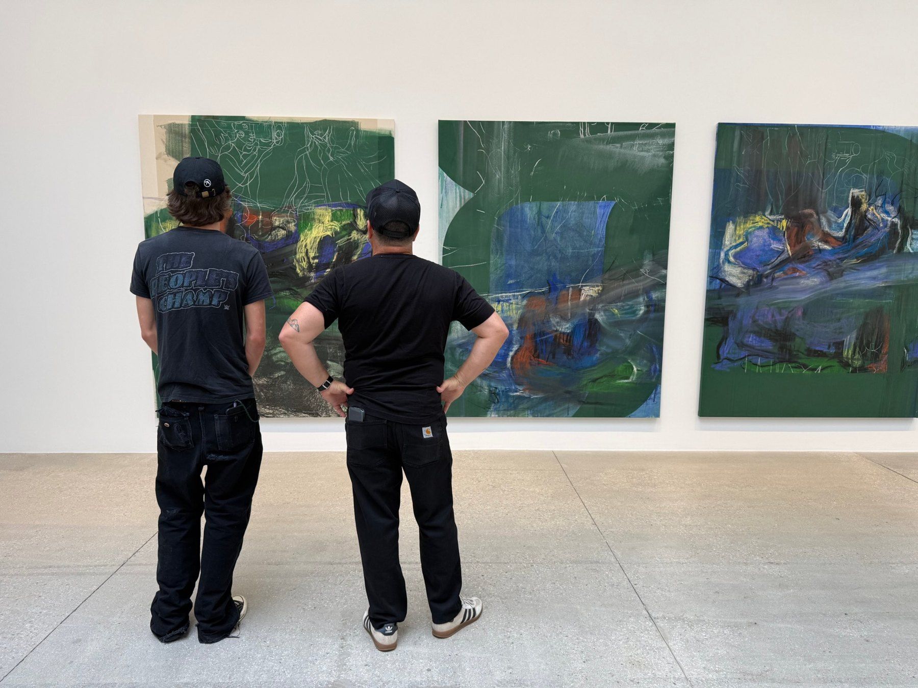 Miguel and a student looking at paintings in a gallery